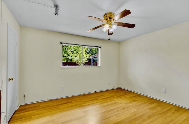 empty room with wood finished floors and ceiling fan