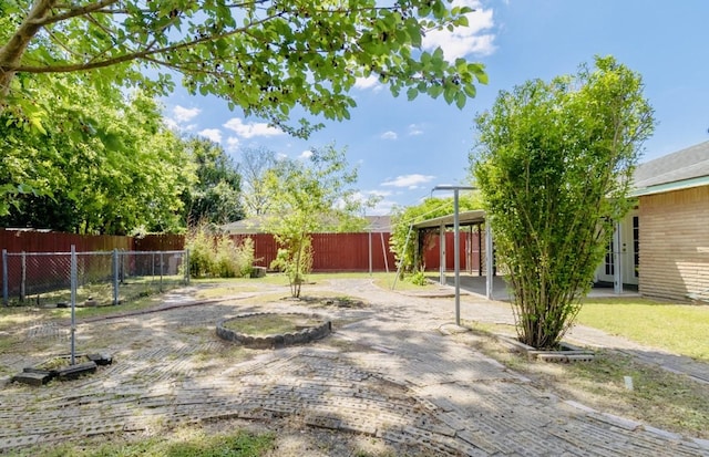 view of yard featuring fence and a patio
