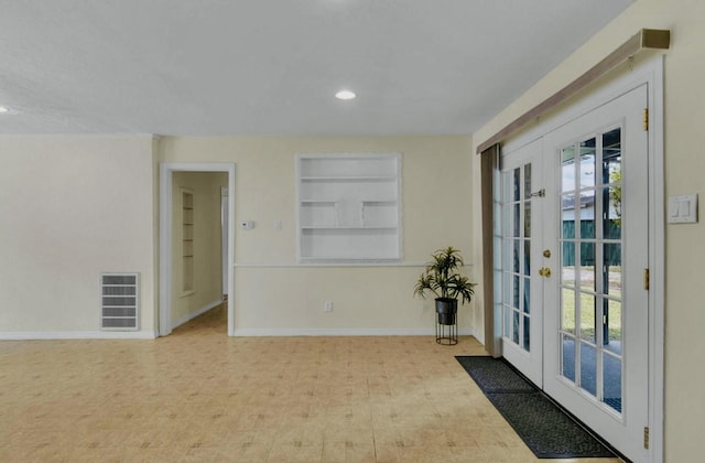 interior space featuring built in shelves, french doors, baseboards, visible vents, and recessed lighting