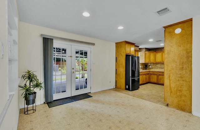 kitchen featuring freestanding refrigerator, french doors, backsplash, visible vents, and recessed lighting