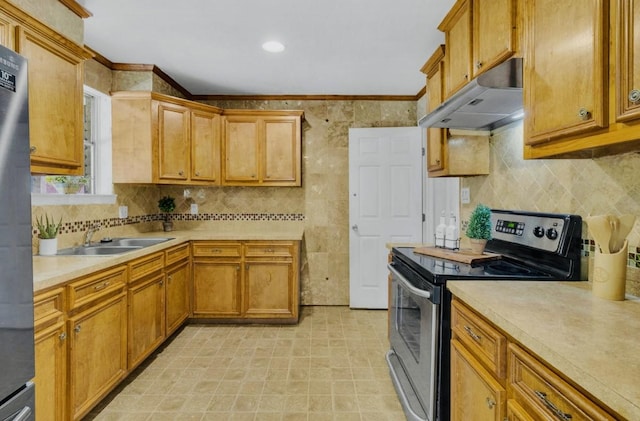 kitchen with tasteful backsplash, a sink, appliances with stainless steel finishes, light countertops, and under cabinet range hood