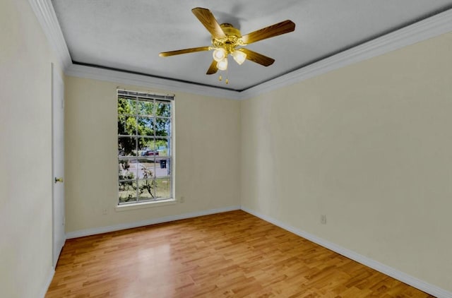 spare room with baseboards, light wood-style floors, ceiling fan, and crown molding