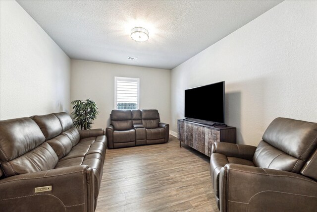 10203 Wylde Point Ln, Missouri City, TX 77459 - living area with wood finished floors and a textured ceiling