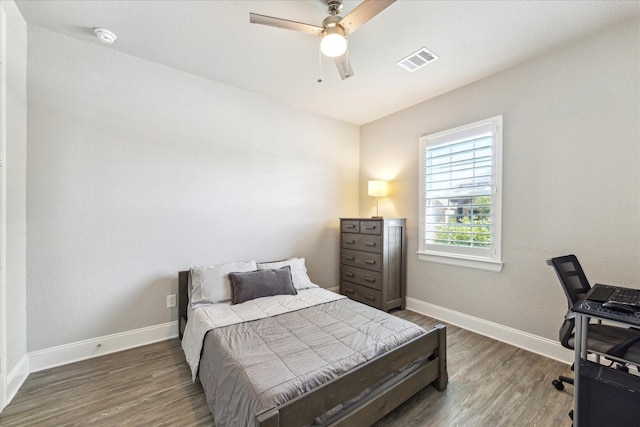 10203 Wylde Point Ln, Missouri City, TX 77459 - bedroom with wood finished floors, baseboards, a ceiling fan, and a desk