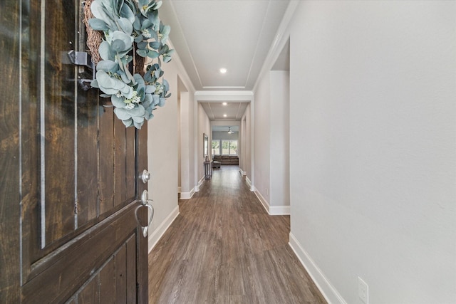 foyer featuring baseboards, ornamental molding, and dark wood-type flooring