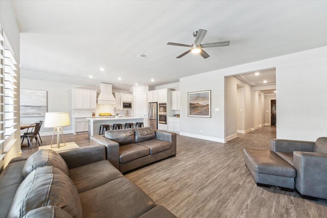 10203 Wylde Point Ln, Missouri City, TX 77459 - living room with ceiling fan, baseboards, wood finished floors, and recessed lighting