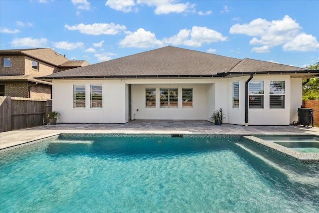 back of house featuring stucco siding, a patio area, a shingled roof, and fence