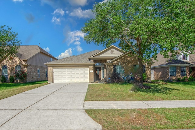 view of front of house with brick siding, a front lawn, driveway, and a garage