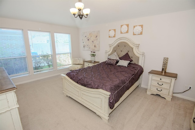 bedroom with light carpet, baseboards, and a chandelier