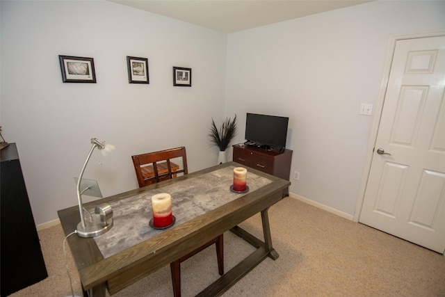 office space with baseboards and light colored carpet
