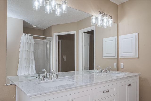 full bathroom with a shower with curtain, double vanity, a textured ceiling, and a sink