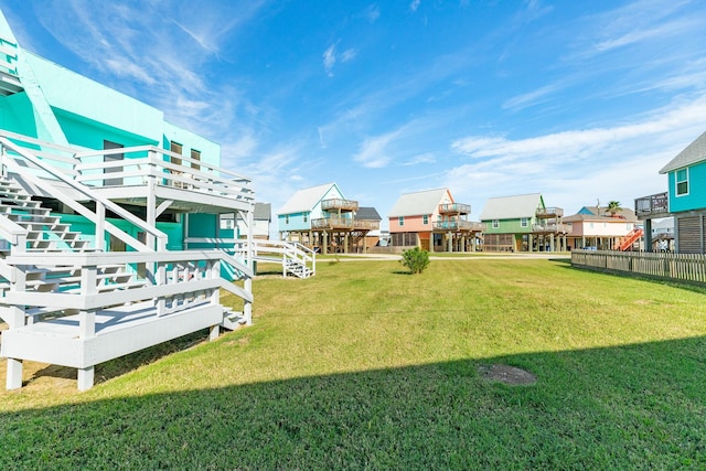 view of yard with a wooden deck and stairs