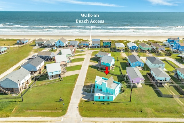 aerial view with a beach view, a water view, and a residential view