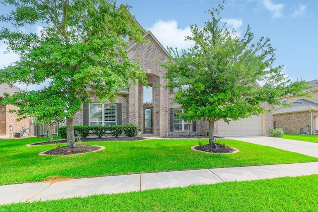 traditional-style home featuring brick siding, a garage, a front lawn, and concrete driveway