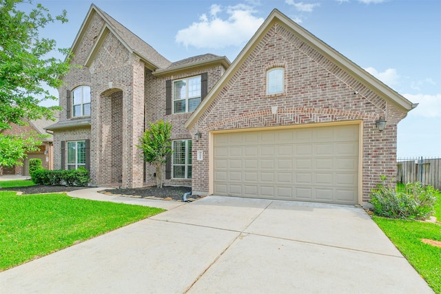 view of front of home with concrete driveway, a front lawn, brick siding, and a garage