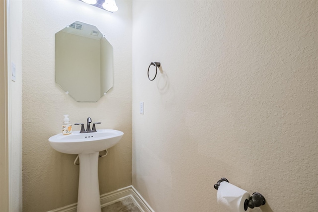 bathroom with baseboards and a sink