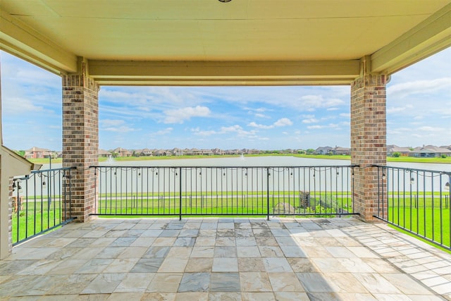view of patio / terrace featuring a residential view and a water view