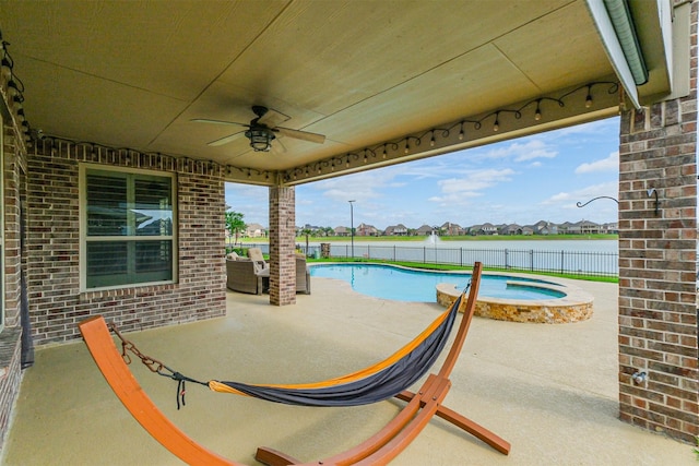 view of patio / terrace featuring a fenced backyard, a pool with connected hot tub, a residential view, and ceiling fan