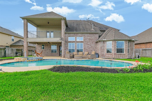 view of swimming pool featuring a fenced backyard, outdoor lounge area, a lawn, a pool with connected hot tub, and a patio