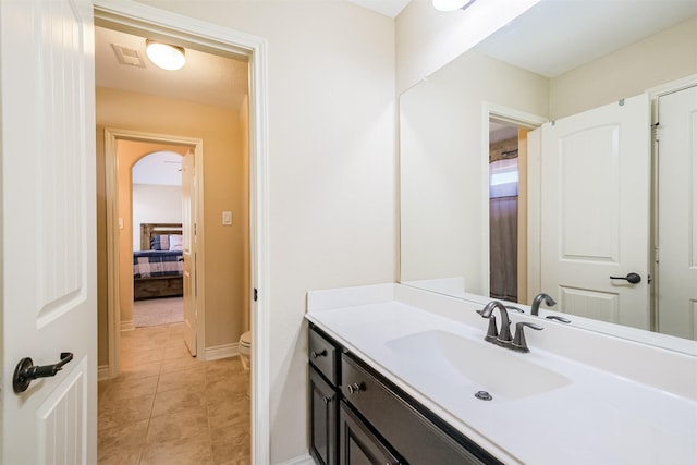 bathroom with tile patterned flooring, visible vents, toilet, vanity, and baseboards