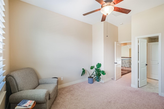 unfurnished room with carpet floors, a ceiling fan, a towering ceiling, and baseboards