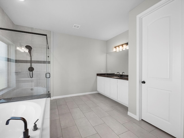bathroom featuring tile patterned floors, a stall shower, vanity, baseboards, and visible vents