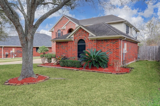 3126 Pebble Bay Dr, League City, TX 77573 - traditional home featuring brick siding, fence, roof with shingles, and a front yard