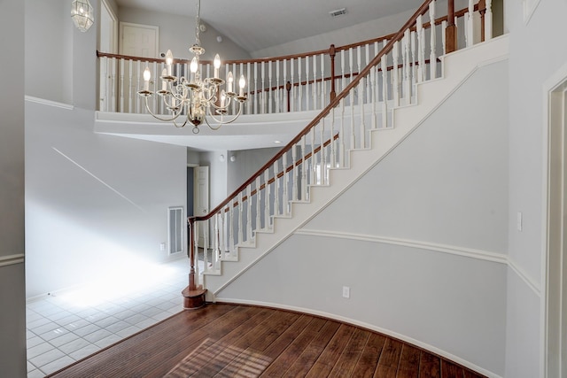 3126 Pebble Bay Dr, League City, TX 77573 - staircase with high vaulted ceiling, a notable chandelier, wood finished floors, and visible vents