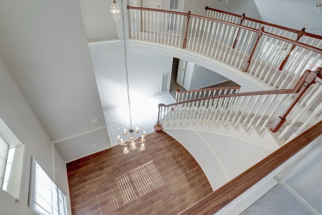 3126 Pebble Bay Dr, League City, TX 77573 - stairway with visible vents, a towering ceiling, a wealth of natural light, and a notable chandelier