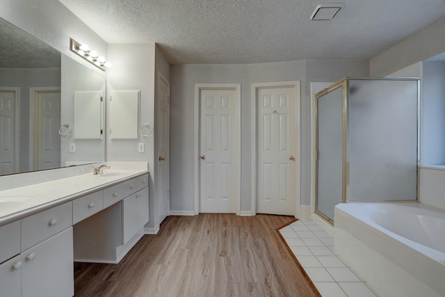 3126 Pebble Bay Dr, League City, TX 77573 - full bathroom with a shower stall, wood finished floors, and a textured ceiling