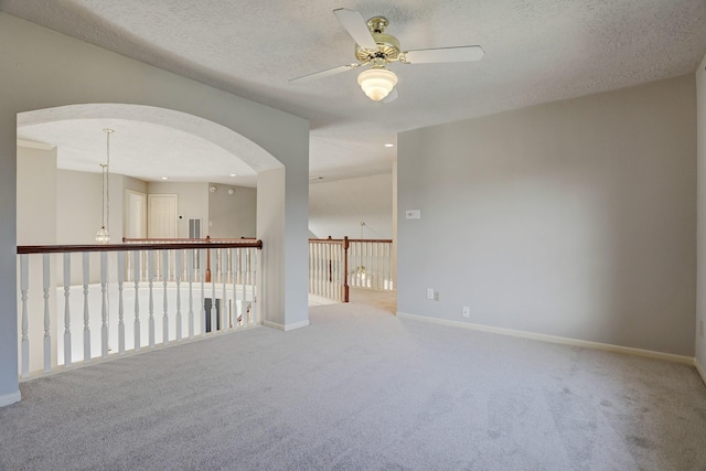 3126 Pebble Bay Dr, League City, TX 77573 - carpeted spare room featuring arched walkways, ceiling fan, baseboards, and a textured ceiling