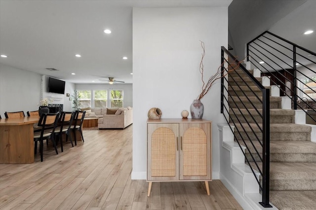 interior space with recessed lighting, light wood finished floors, stairs, and ceiling fan