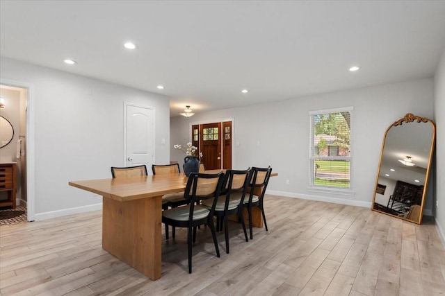 interior space with baseboards, a wealth of natural light, light wood finished floors, and recessed lighting