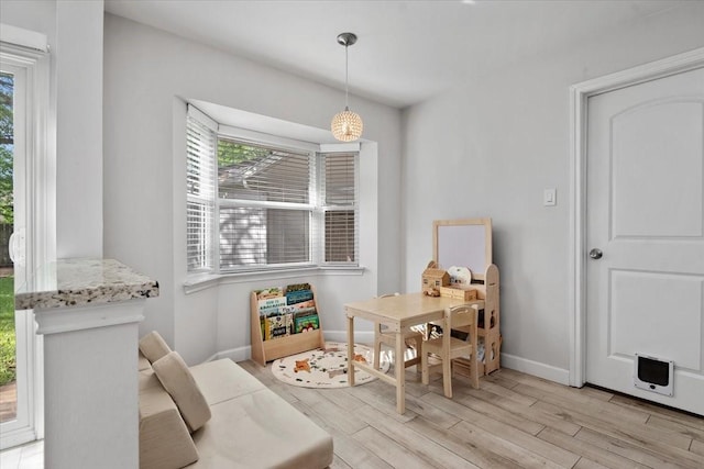 dining room featuring light wood-style flooring and baseboards