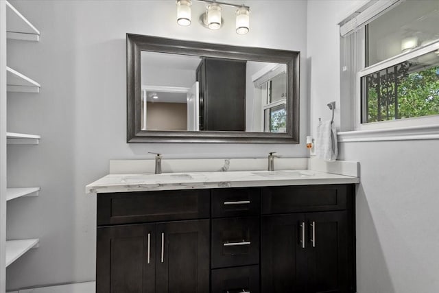 bathroom featuring a sink and double vanity
