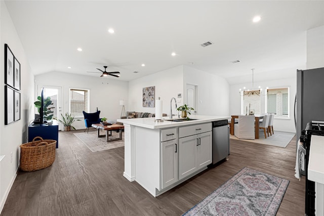 24343 Elmwood Falls Dr, Spring, TX 77373 - kitchen with appliances with stainless steel finishes, a sink, dark wood finished floors, light countertops, and a chandelier