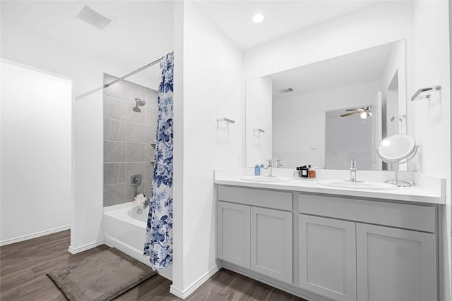 24343 Elmwood Falls Dr, Spring, TX 77373 - bathroom featuring wood finished floors, double vanity, shower / tub combo with curtain, baseboards, and a ceiling fan