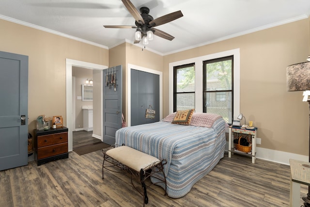 bedroom featuring dark wood finished floors, baseboards, ornamental molding, and ensuite bath