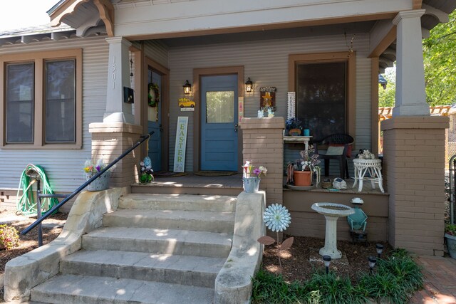 view of exterior entry featuring a porch