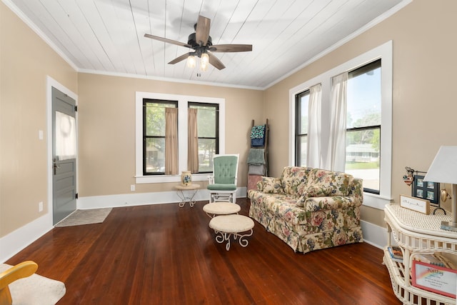 living area featuring wood finished floors, wood ceiling, ornamental molding, ceiling fan, and baseboards