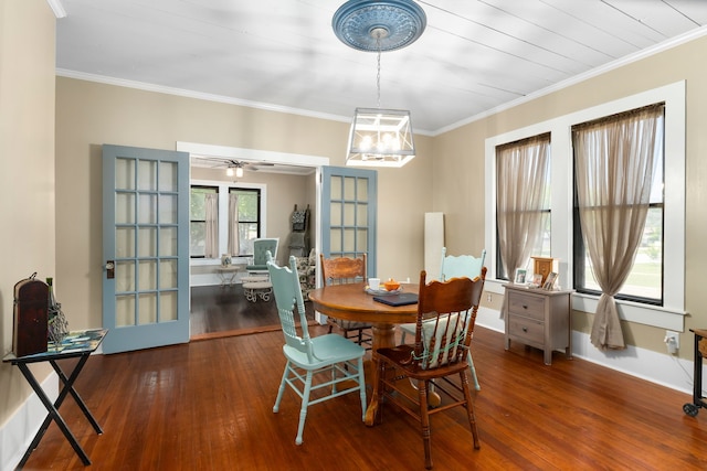 dining room with a chandelier, hardwood / wood-style flooring, and ornamental molding