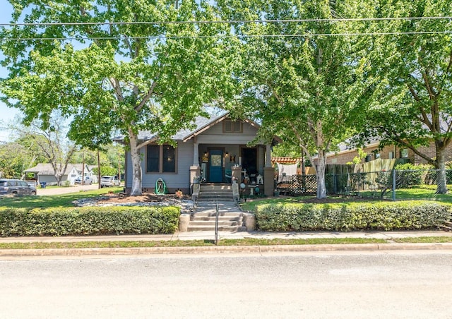 view of front of home featuring fence and a porch