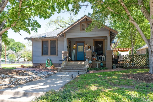 bungalow with a porch and fence