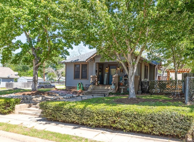 bungalow-style house featuring fence and a porch