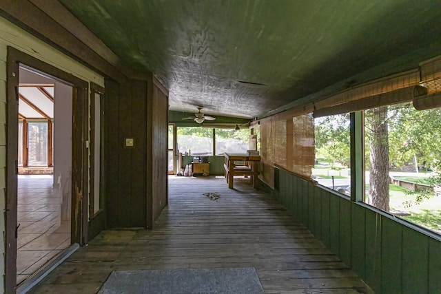 wooden terrace featuring a ceiling fan