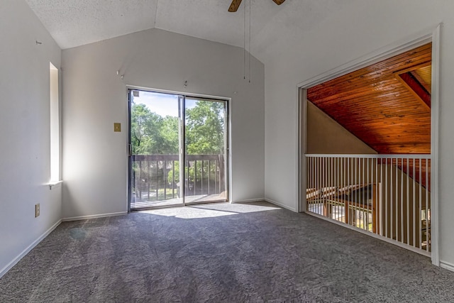 interior space with vaulted ceiling, baseboards, carpet floors, and a ceiling fan