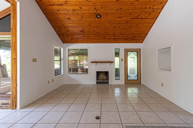 unfurnished living room featuring wooden ceiling, light tile patterned floors, and a healthy amount of sunlight