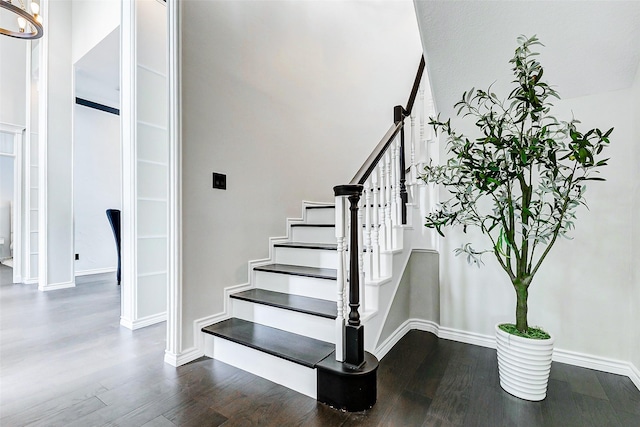 stairs with wood finished floors and baseboards