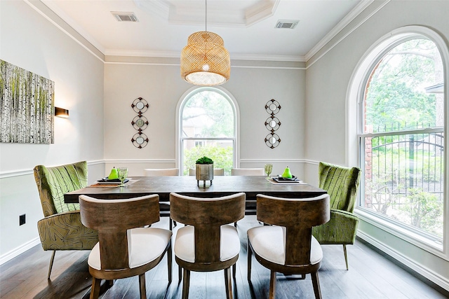 dining area with wood finished floors, ornamental molding, and baseboards