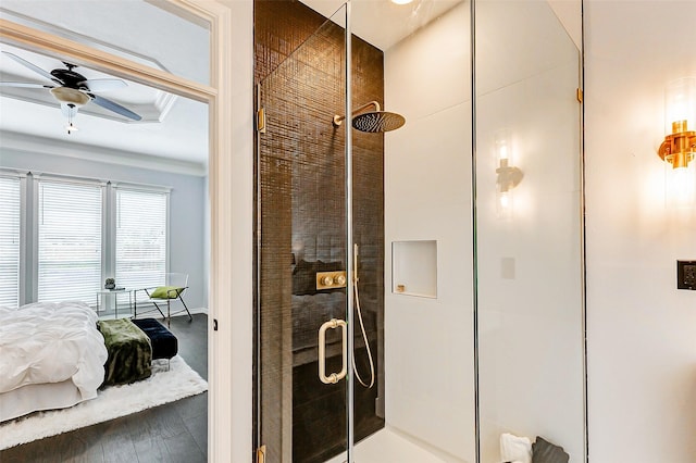 bathroom featuring a shower stall, ensuite bathroom, ceiling fan, and baseboards